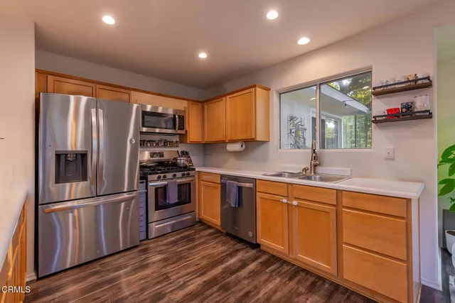 a kitchen with stainless steel appliances a refrigerator and a sink