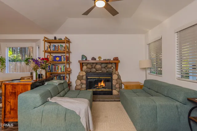a living room with furniture and a fireplace