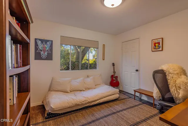 a living room with furniture rug and a window