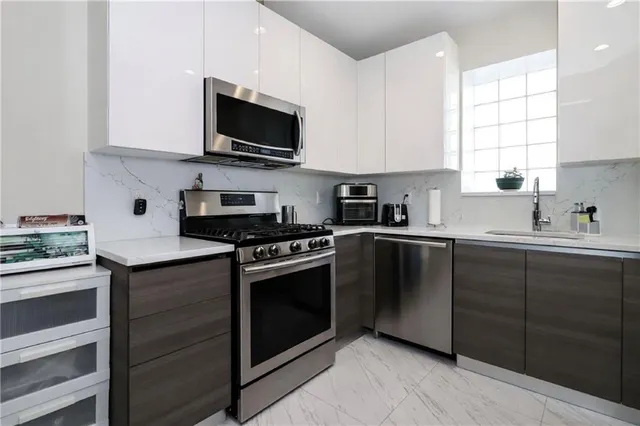 a kitchen with cabinets and stainless steel appliances