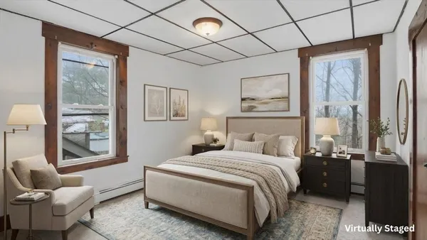 a bedroom with a bed and glass window
