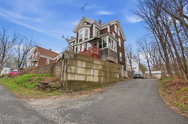 a view of a house with a yard and garage