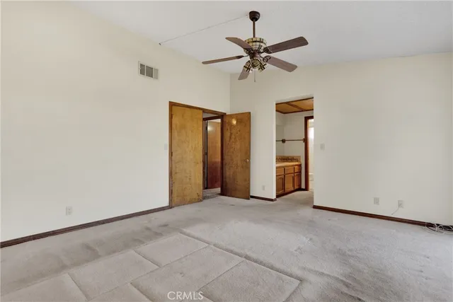 a view of a livingroom with a ceiling fan and window
