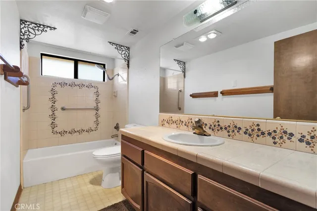 a bathroom with a sink a bathtub and a mirror