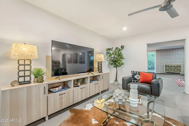 a kitchen with a sink a stove a refrigerator and white cabinets