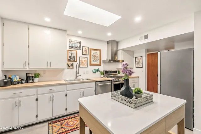 a view of a dining room with furniture and a flat screen tv
