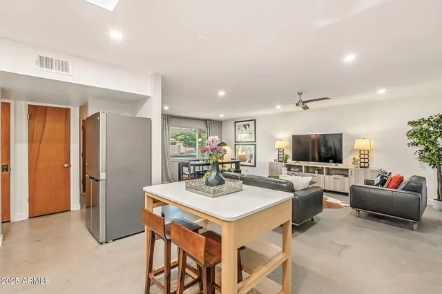 a kitchen with stainless steel appliances granite countertop a sink and a stove next to a window