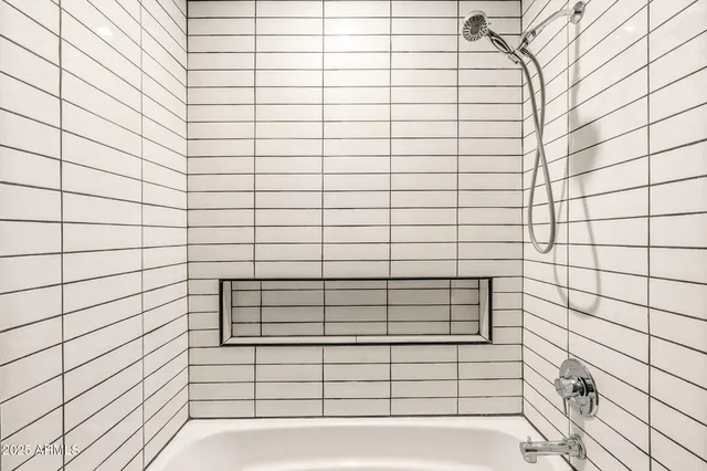 a bedroom with a bed and flat screen tv