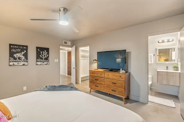 a bedroom with a bed and a window