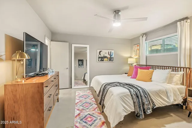 a bedroom with a bed and a flat screen tv