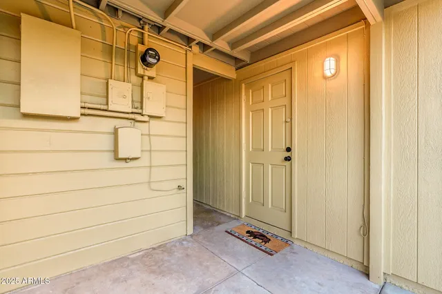 a backyard of a house with table and chairs