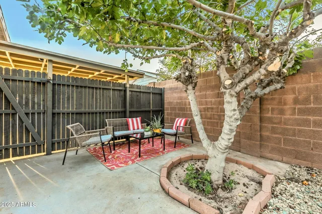 a backyard of a house with table and chairs