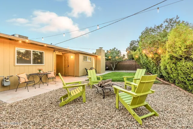 a view of a patio with table and chairs and potted plants