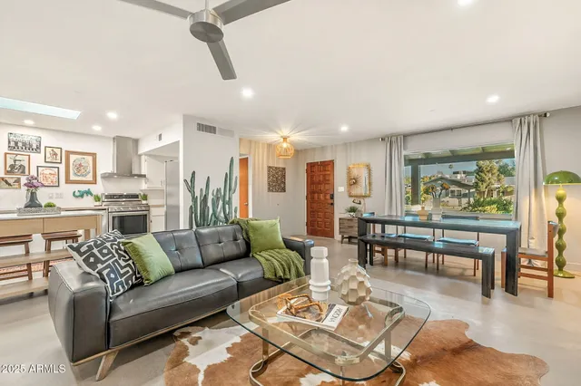 a dining room with wooden floor and large window
