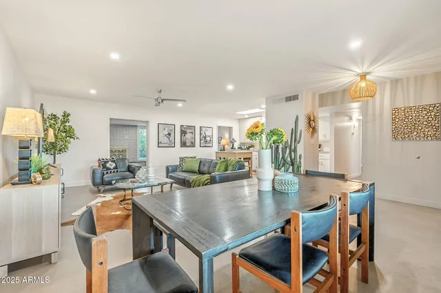 a living room with furniture a rug and a floor to ceiling window