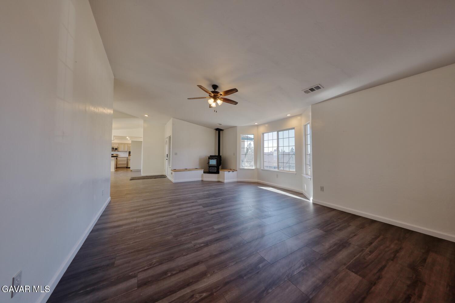 26801 Cabriolet Court Tehachapi, CA 93561 - Photo 9 of 60 a view of a livingroom with wooden floor and a ceiling fan