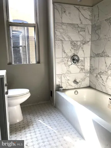 a bathroom with a sink a toilet and bathtub