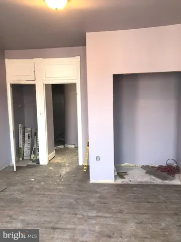 a view of a room with wooden floor