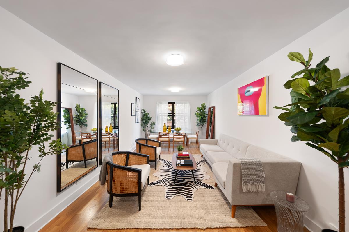 a living room with furniture and a potted plant