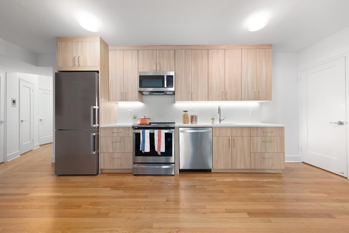 425 Central Park West, Unit 3J Manhattan, NY 10025 - Photo 3 of 9 a kitchen with kitchen island a counter top space stainless steel appliances and cabinets