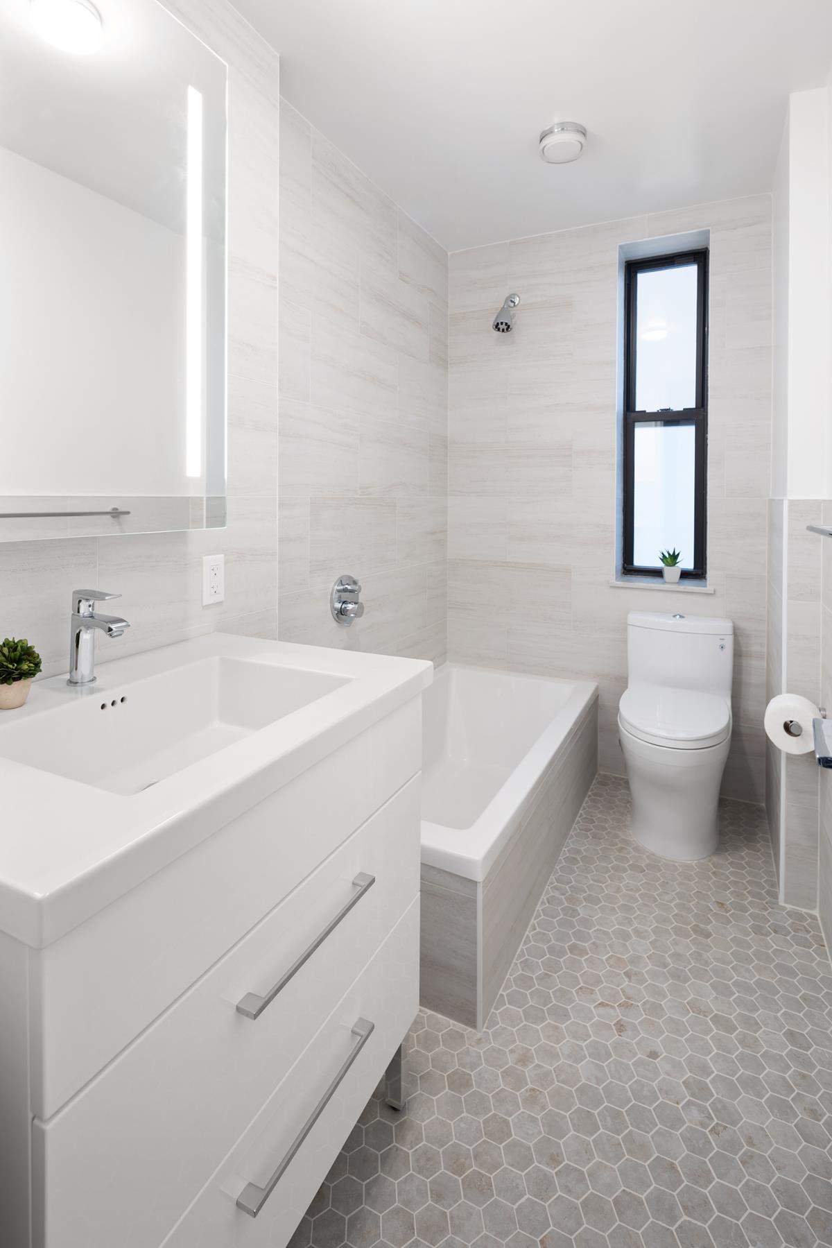 425 Central Park West, Unit 3J Manhattan, NY 10025 - Photo 7 of 9 a spacious bathroom with a sink a toilet and a bathtub