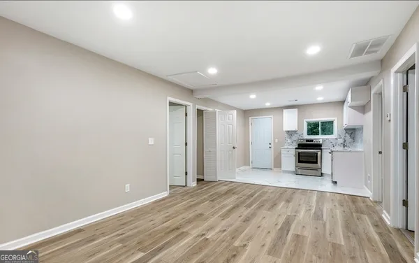a view of a kitchen with a sink and a stove top oven