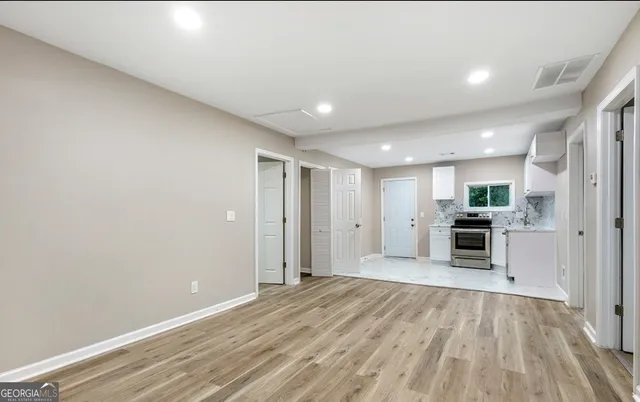 a view of a kitchen with a sink and a stove top oven