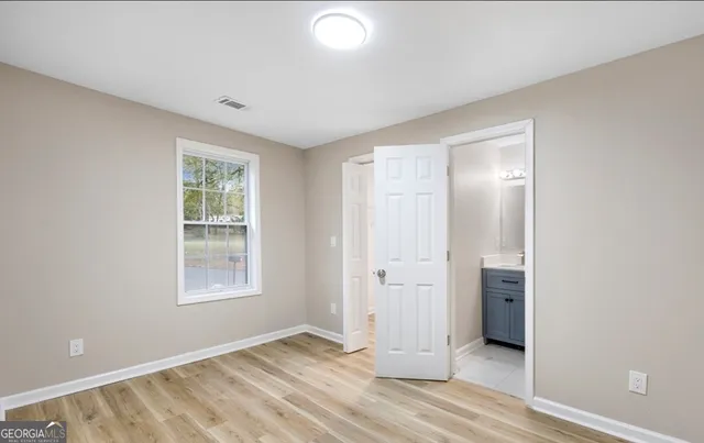 an empty room with windows and closet