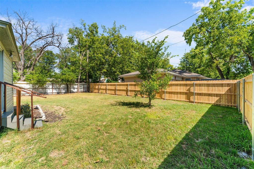 612 East 8th Street Kemp, TX 75143 - Photo 25 of 25 Expansive backyard featuring a new wood privacy fence, mature trees, and a substantial grassy area