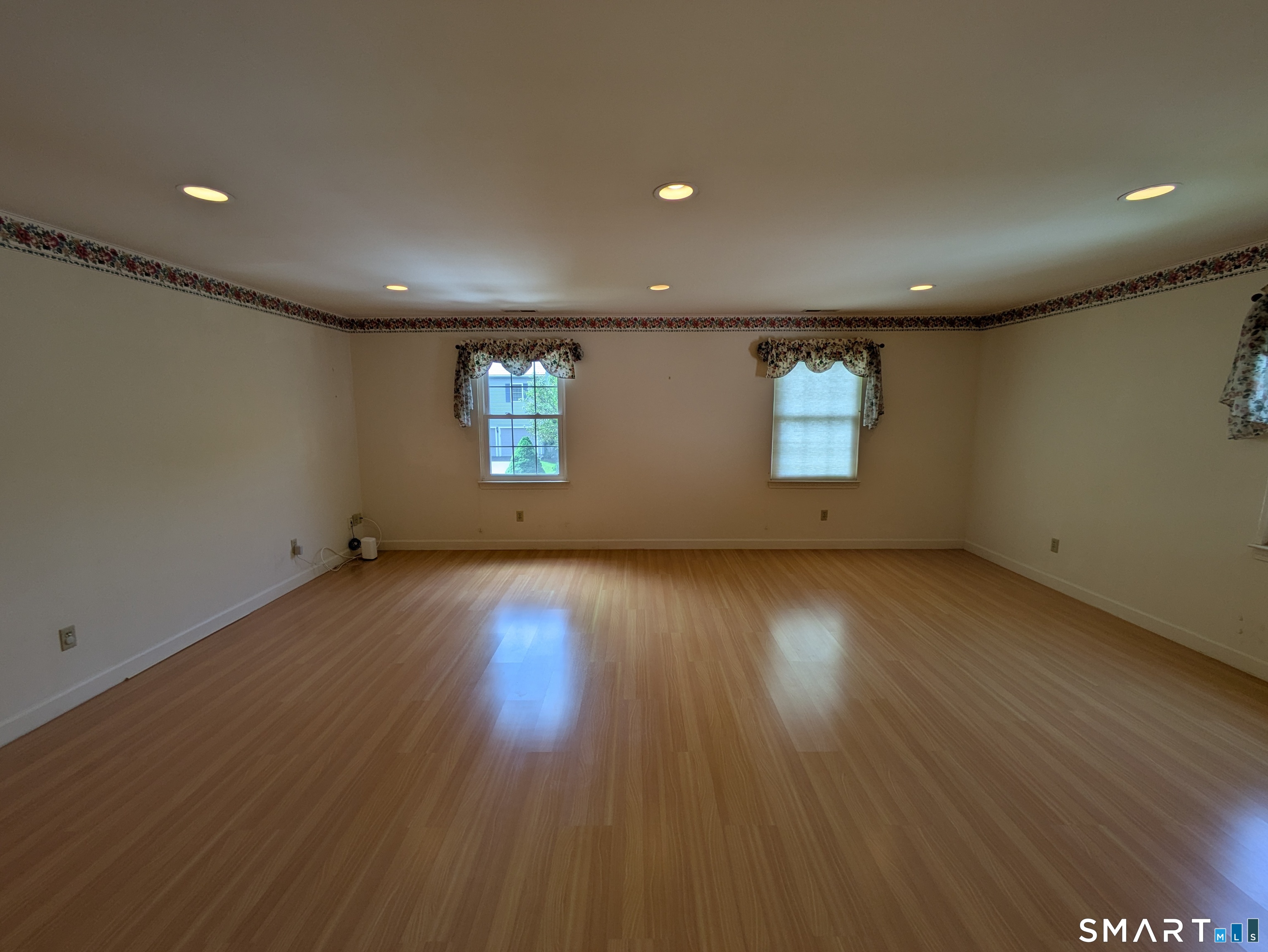 61 Basking Brook Road Shelton, CT 06484 - Photo 21 of 25 an empty room with wooden floor and windows