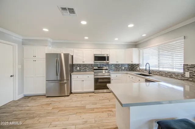 a kitchen with refrigerator and microwave