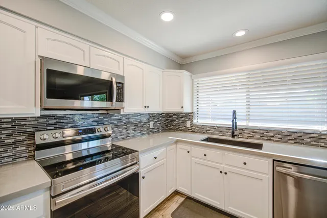 a kitchen with granite countertop a sink and a stove