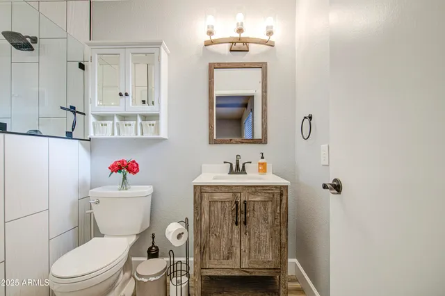a bathroom with a toilet sink and mirror