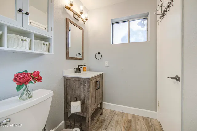 a bathroom with a toilet a sink and a mirror