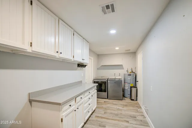 a kitchen with cabinets and stainless steel appliances