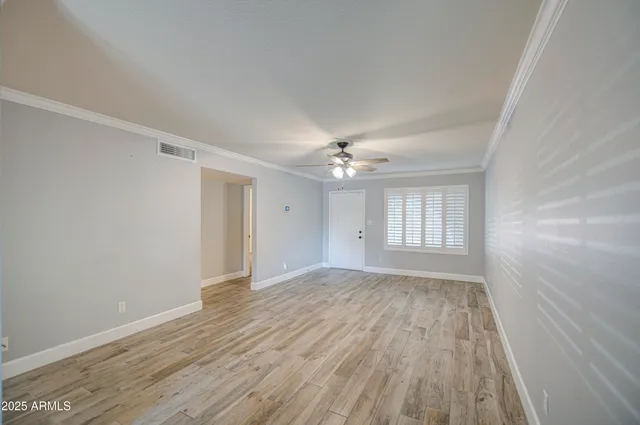 wooden floor in an empty room with a window