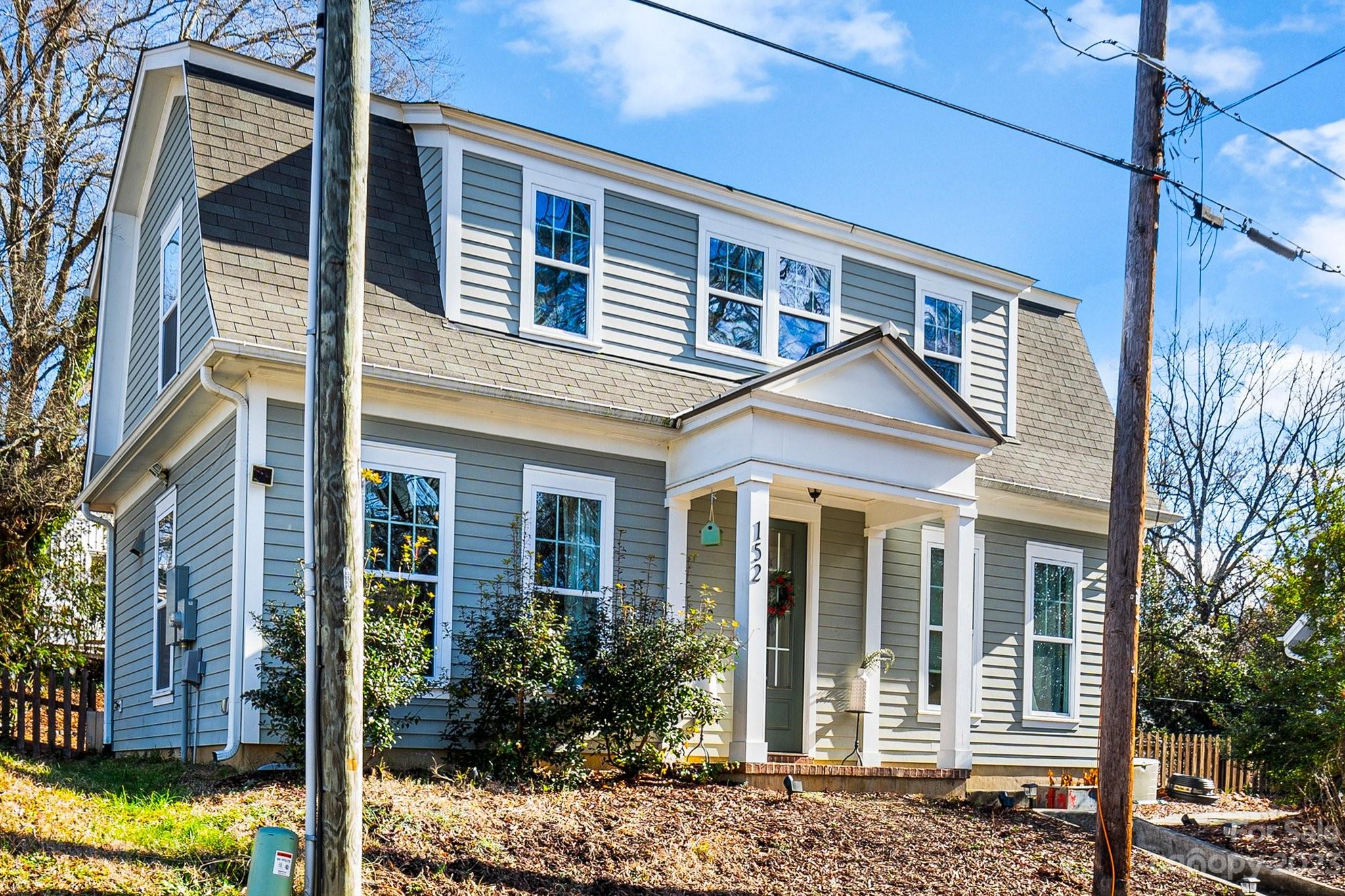 a front view of a house with a garden
