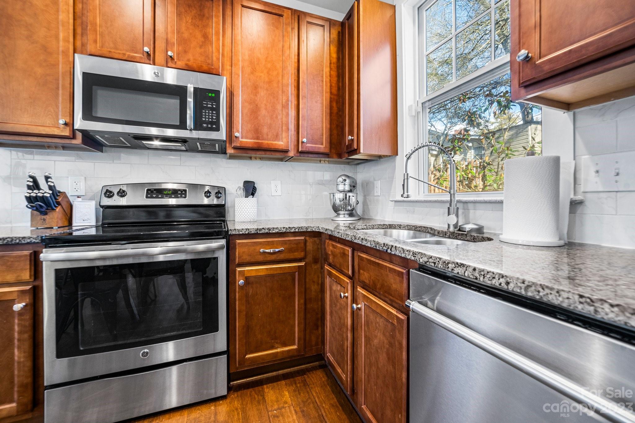 152 Mock Road Davidson, NC 28036 - Photo 12 of 29 a kitchen with stainless steel appliances granite countertop a stove microwave and sink