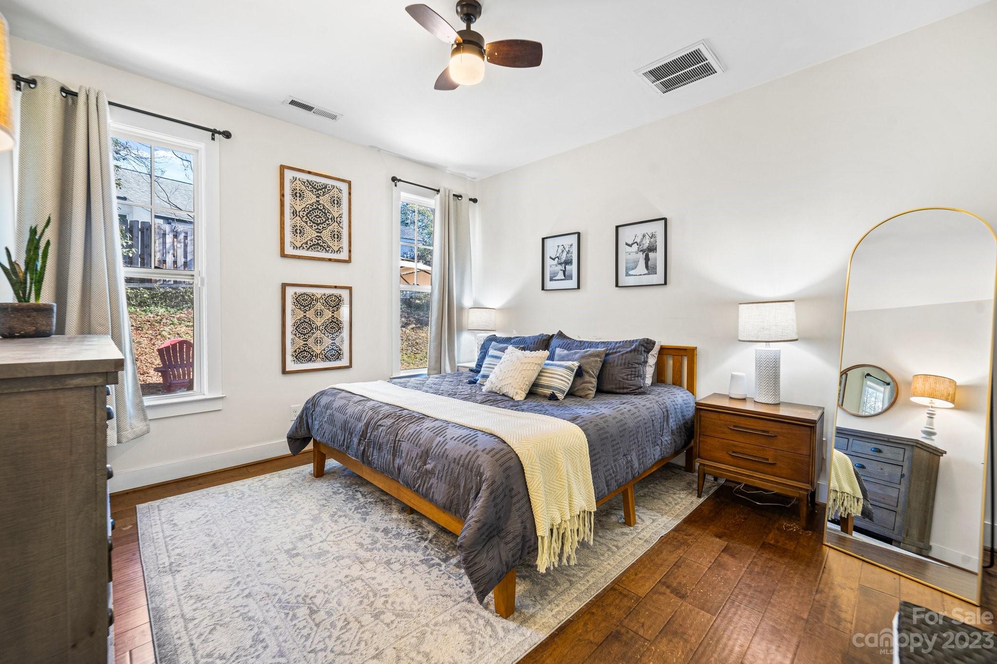 152 Mock Road Davidson, NC 28036 - Photo 14 of 29 a spacious bedroom with a bed a mirror and a window