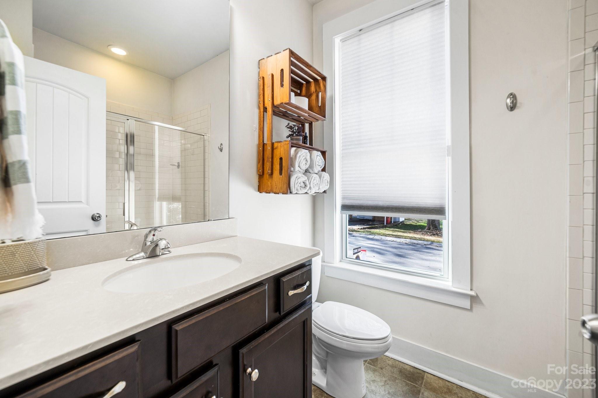 152 Mock Road Davidson, NC 28036 - Photo 15 of 29 a bathroom with a sink a toilet and a mirror