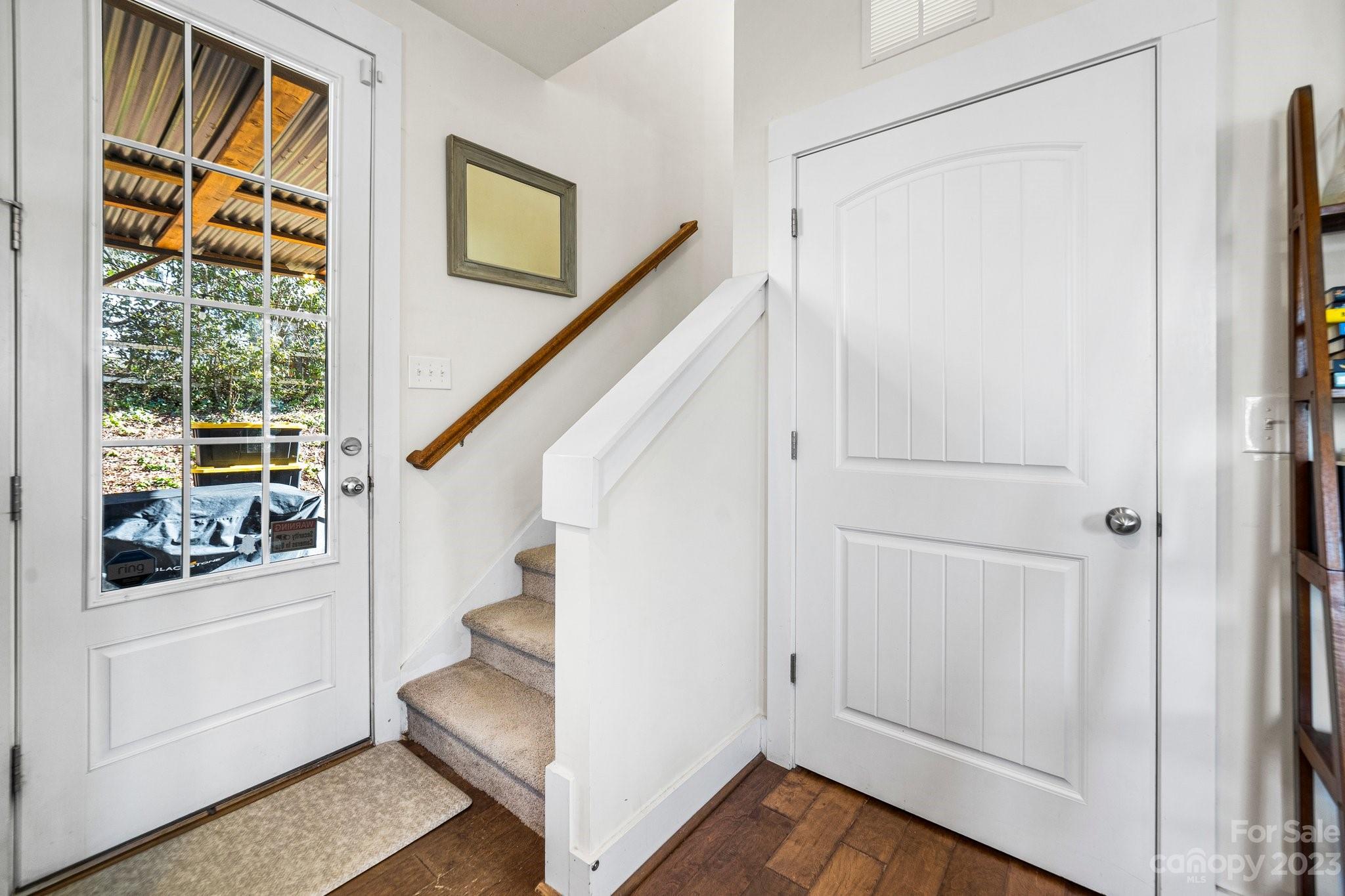 152 Mock Road Davidson, NC 28036 - Photo 17 of 29 a view of entryway with wooden floor and stair