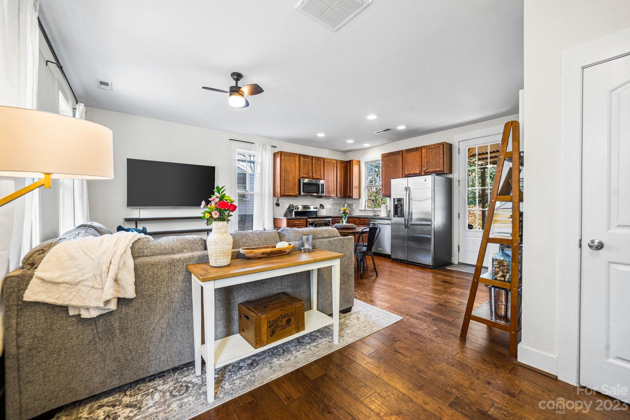 152 Mock Road Davidson, NC 28036 - Photo 5 of 29 a living room with stainless steel appliances furniture a fireplace and a flat screen tv