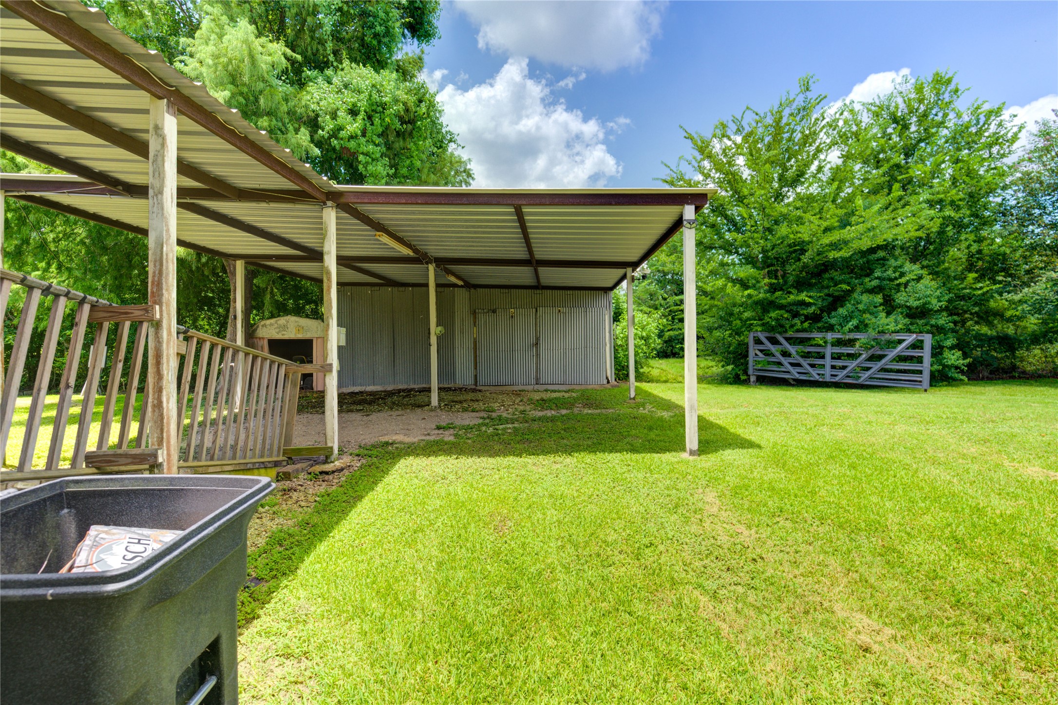3330 Euell Road Crosby, TX 77532 - Photo 6 of 9 a view of a backyard with a tub and wooden fence
