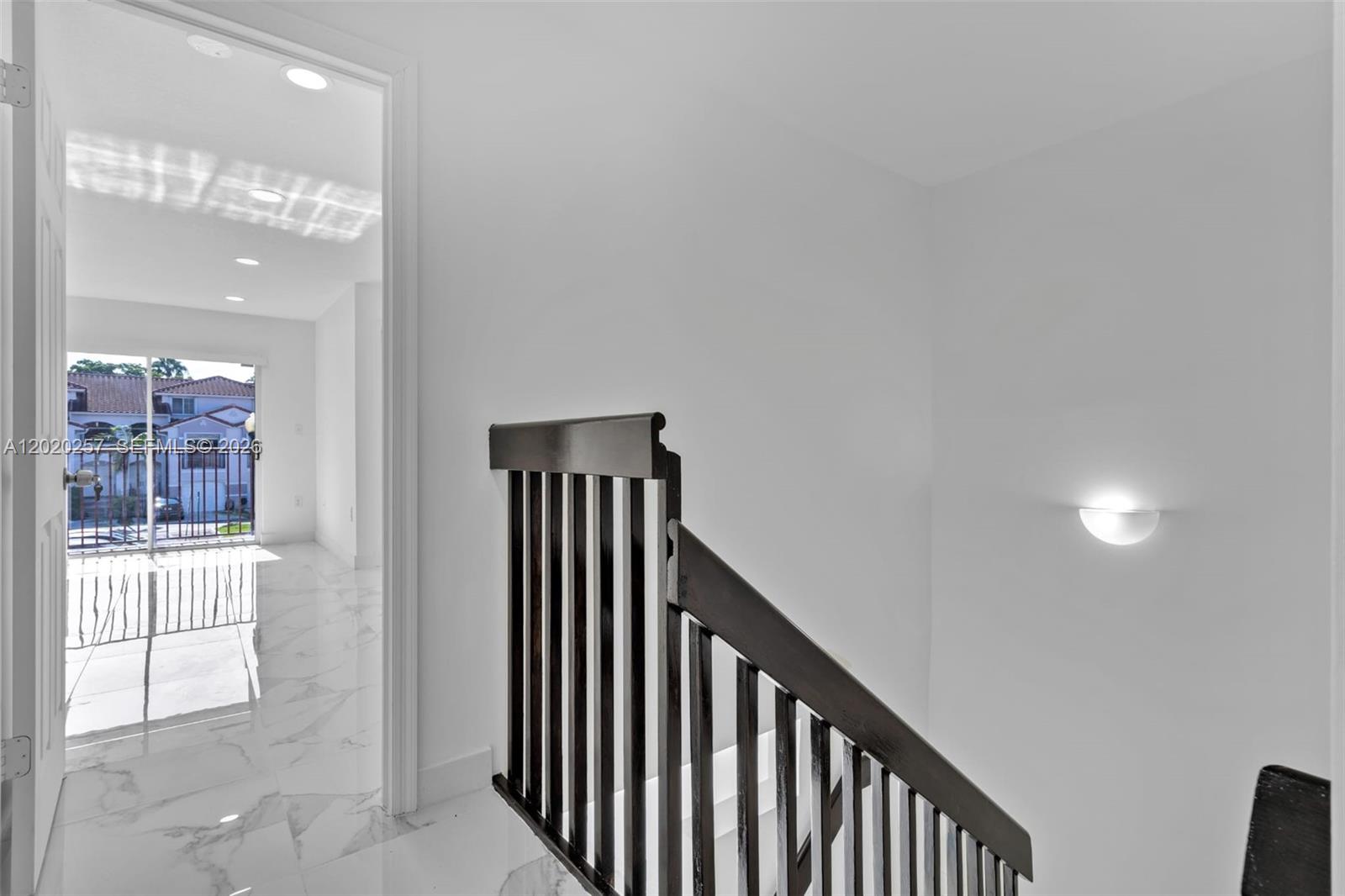 10245 Southwest 154th Place, Unit 1123 Miami, FL 33196 - Photo 10 of 38 a view of a hallway with wooden floor and staircase