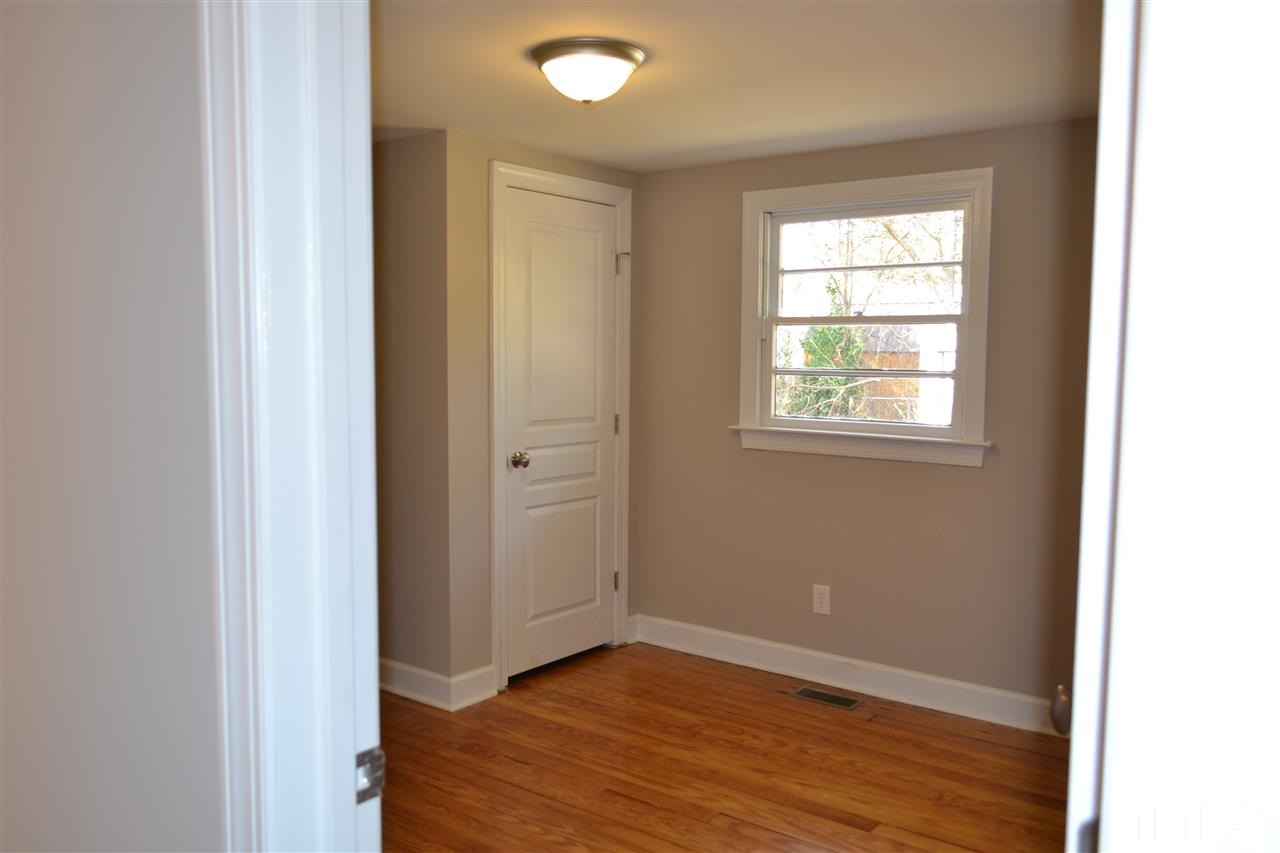 1504 Wiljohn Road Garner, NC 27529 - Photo 14 of 22 a view of an empty room with wooden floor and a window