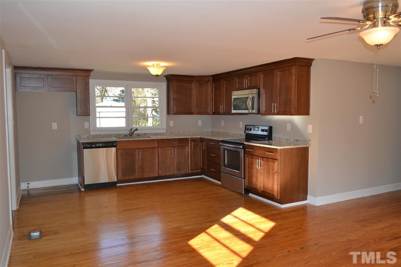 1504 Wiljohn Road Garner, NC 27529 - Photo 22 of 22 a kitchen with granite countertop a stove a sink and a microwave
