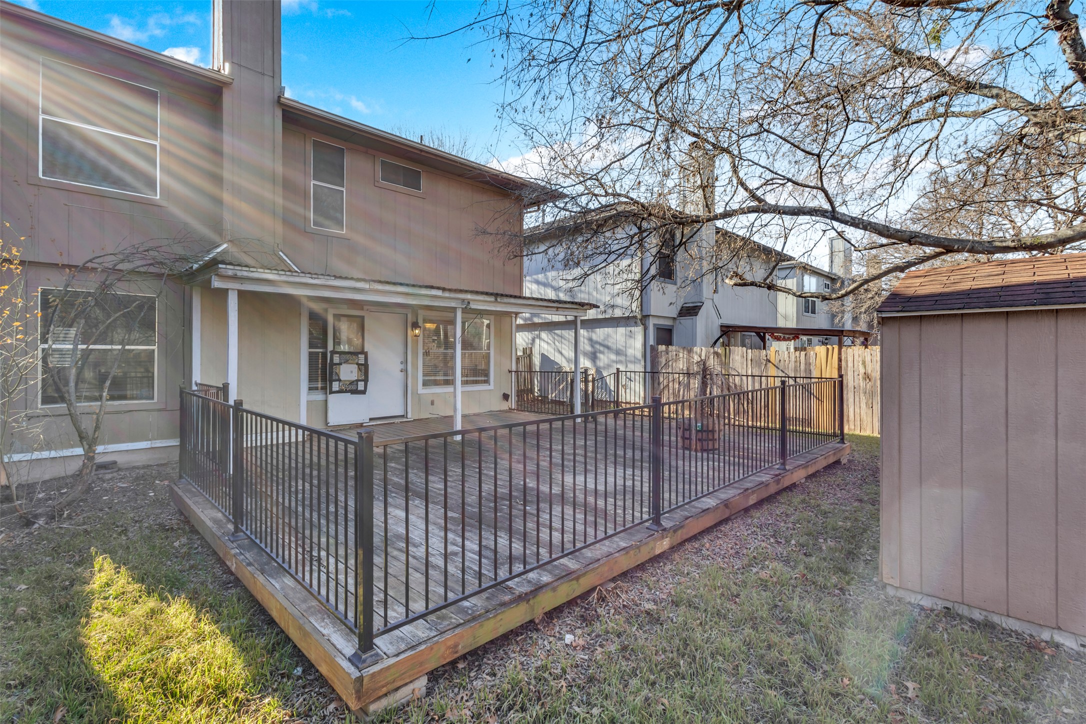 12922 Marimba Trail Austin, TX 78729 - Photo 21 of 28 Back of house with a fenced backyard, a shed, and a patio