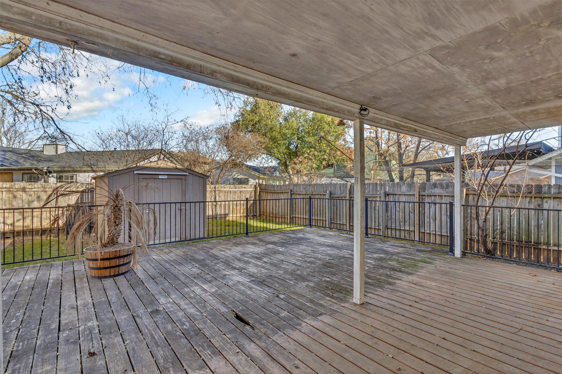 12922 Marimba Trail Austin, TX 78729 - Photo 22 of 28 Wooden deck featuring a storage shed and a fenced backyard