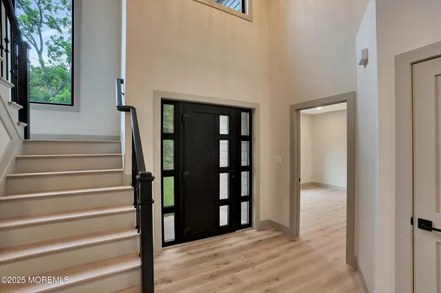 a large kitchen with stainless steel appliances a large counter top a sink a chimney and a window