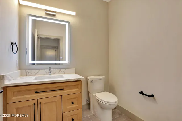 a large kitchen with stainless steel appliances a large center island wooden floor stainless steel appliances and cabinets